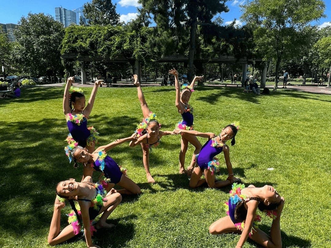 Boston Rhythmic campers posing together outdoors in a park on a sunny summer day
