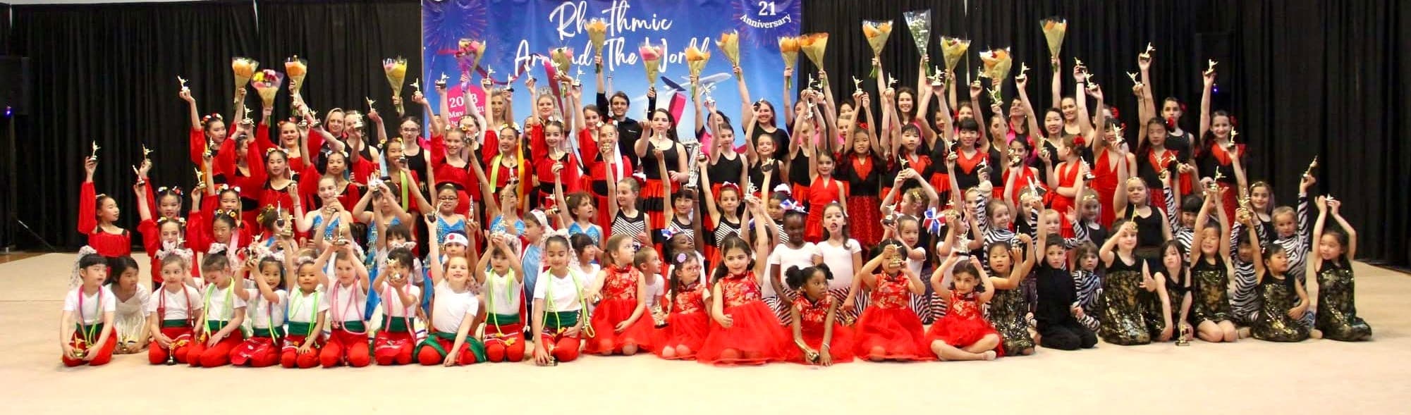 Boston Rhythmic students celebrating with trophies